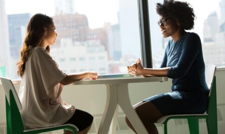 https://www.pexels.com/photo/two-women-sitting-on-chairs-beside-window-1181719/