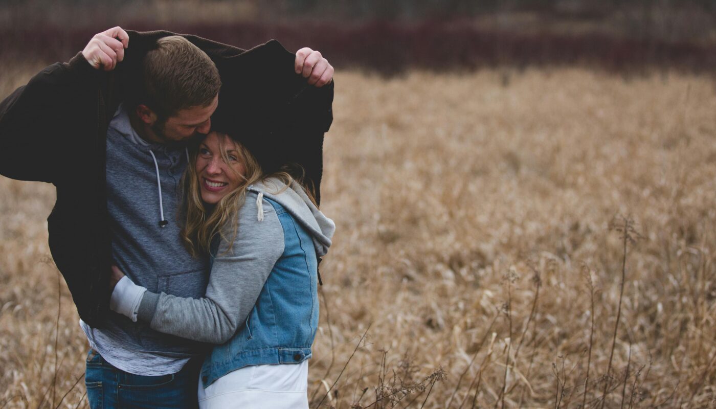 https://www.pexels.com/photo/man-and-woman-hugging-on-brown-field-853407/