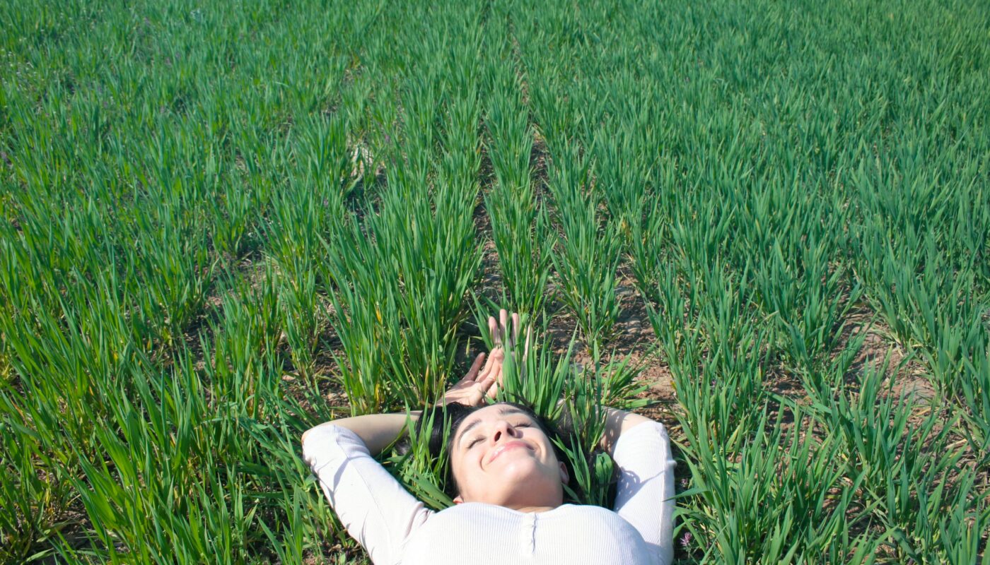 https://www.pexels.com/photo/woman-laying-on-field-of-green-grass-755026/