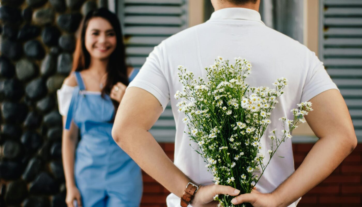 https://www.pexels.com/photo/man-holding-baby-s-breath-flower-in-front-of-woman-standing-near-marble-wall-935789/