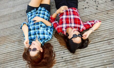 https://www.pexels.com/photo/two-woman-wearing-blue-and-red-sport-shirts-and-sunglasses-lying-on-brown-surface-58592/