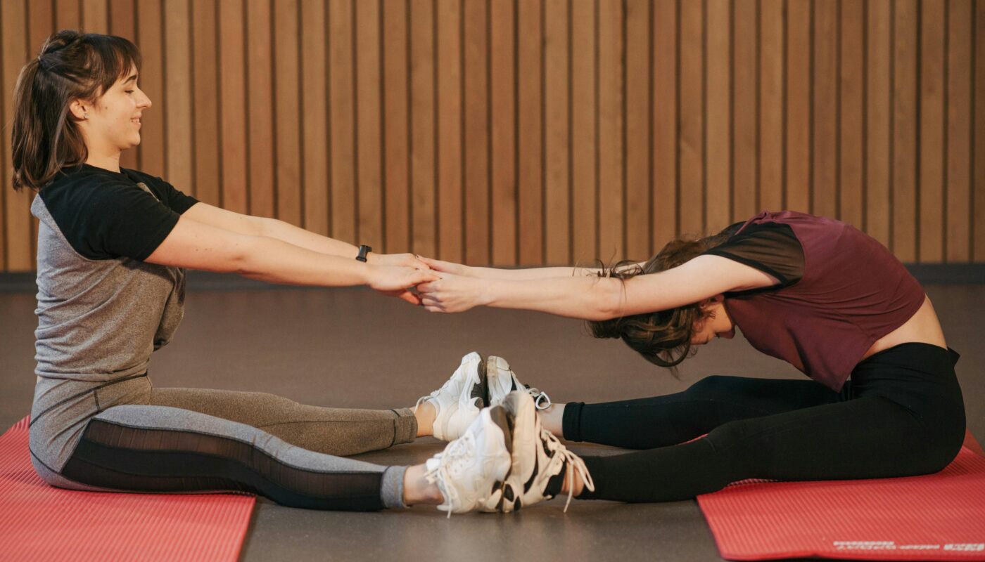 https://www.pexels.com/photo/woman-helping-another-woman-stretch-her-body-6339395/