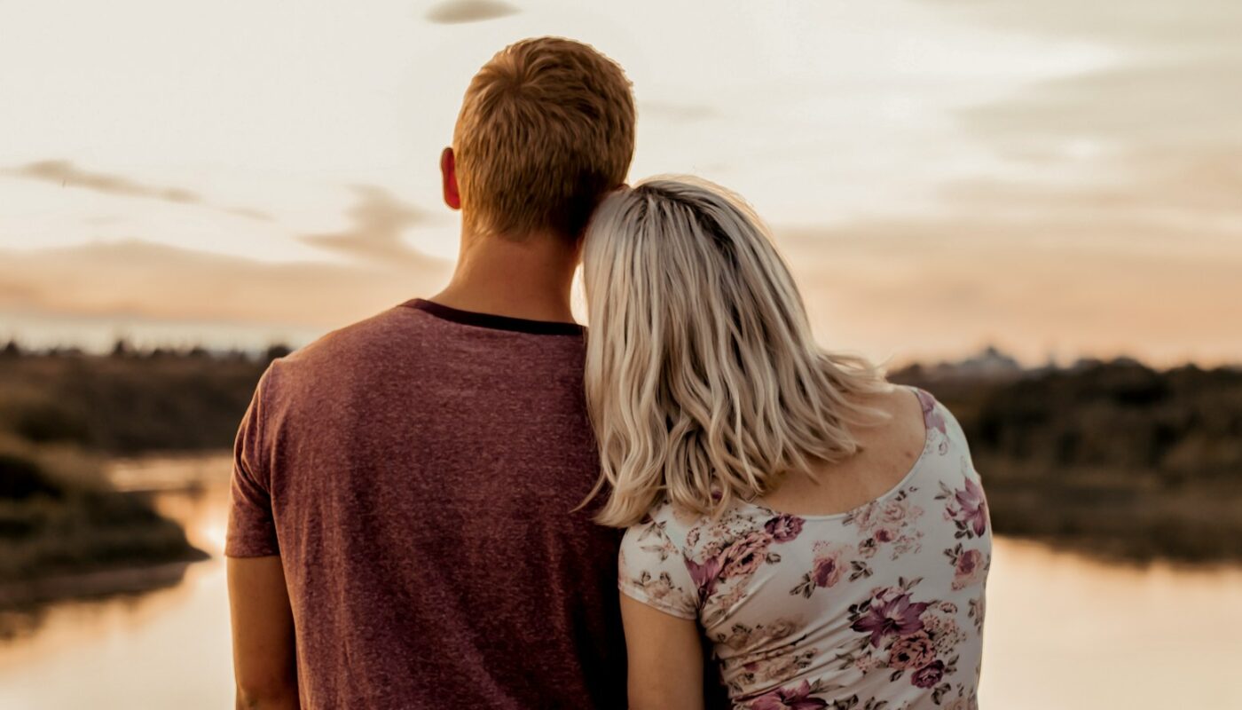 man and woman standing on brown field during daytime