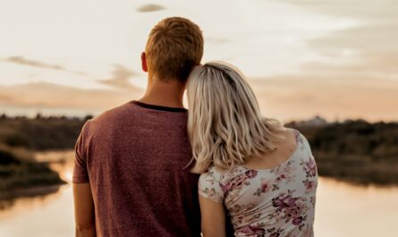 man and woman standing on brown field during daytime