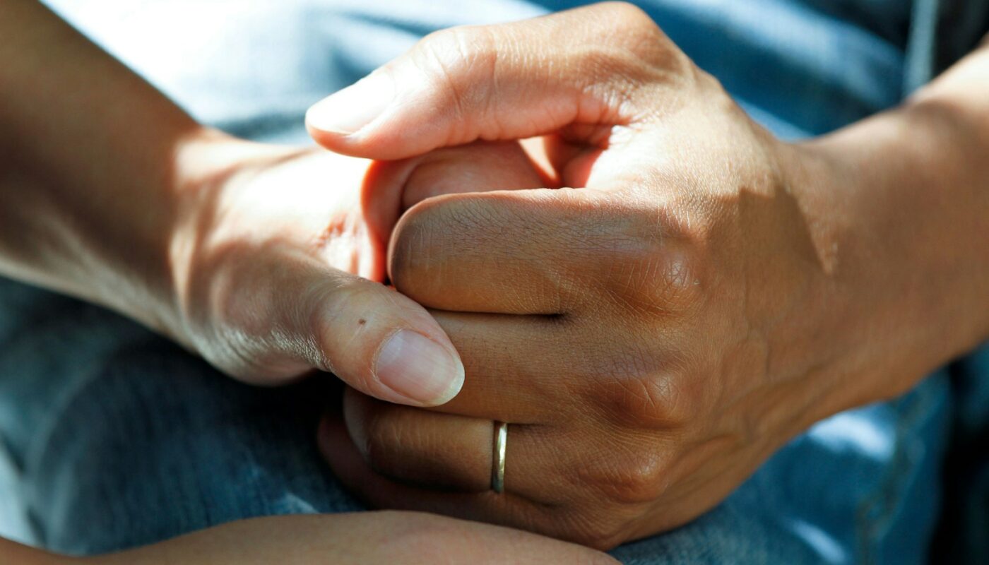 person wearing gold wedding band