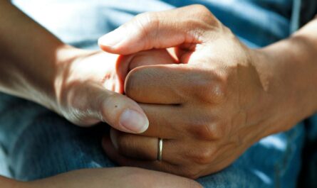 person wearing gold wedding band