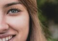 smiling woman with blonde hair in selective focus photography