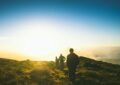 silhouette of three men falling in line while walking during golden hour