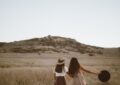 two women walking around near mountain at daytime