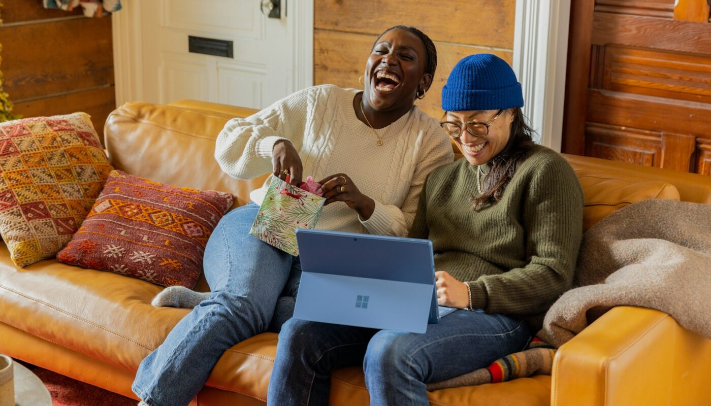 a person sitting on a couch with a laptop